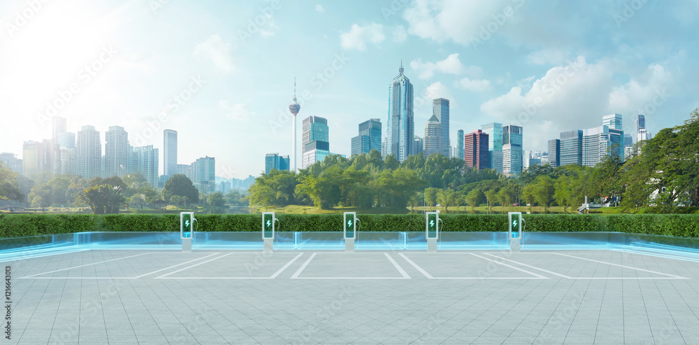 Fototapeta premium Empty parking lot with ev charging stations and kuala lumpur cityscape