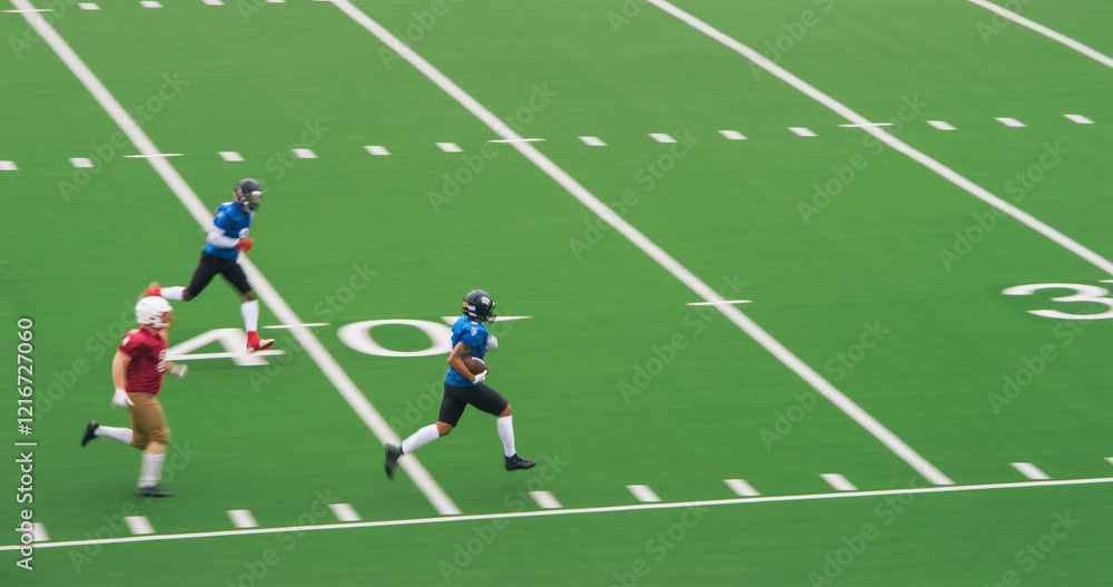 American Football Match with Diverse Male Athletes in Red and Blue Jerseys Run in a Field, Battle for the Ball. Athletic Player Runs with the Ball American Football Match with Diverse Male Athletes in Red and Blue Jerseys Run in a Field, Battle for the Ball. Athletic Player Runs with the Ball