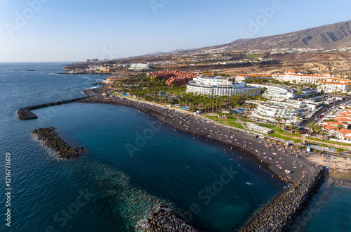 Adeje, Tenerife Spain - 10.12.2024: Aerial drone view of the stunning El Beril beach in south Tenerife. With extraordinary black volcanic sand. photo