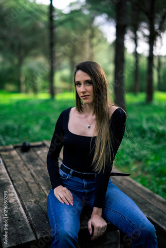 Obraz na płótnie Chica joven delgada vloggeando con cámara por zona verde con arboles w salonie