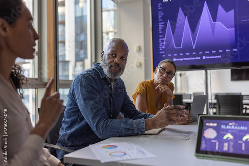 Mature African American businessman listening in a team meeting