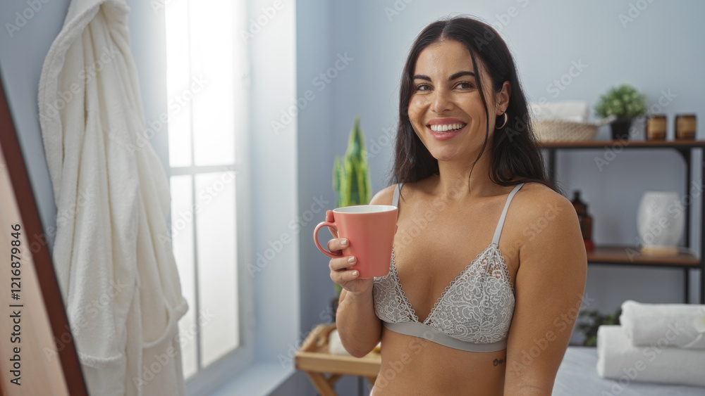 Smiling woman enjoying coffee in a spa room, wearing lingerie and standing near a window with spa accessories in the background Smiling woman enjoying coffee in a spa room, wearing lingerie and standing near a window with spa accessories in the background