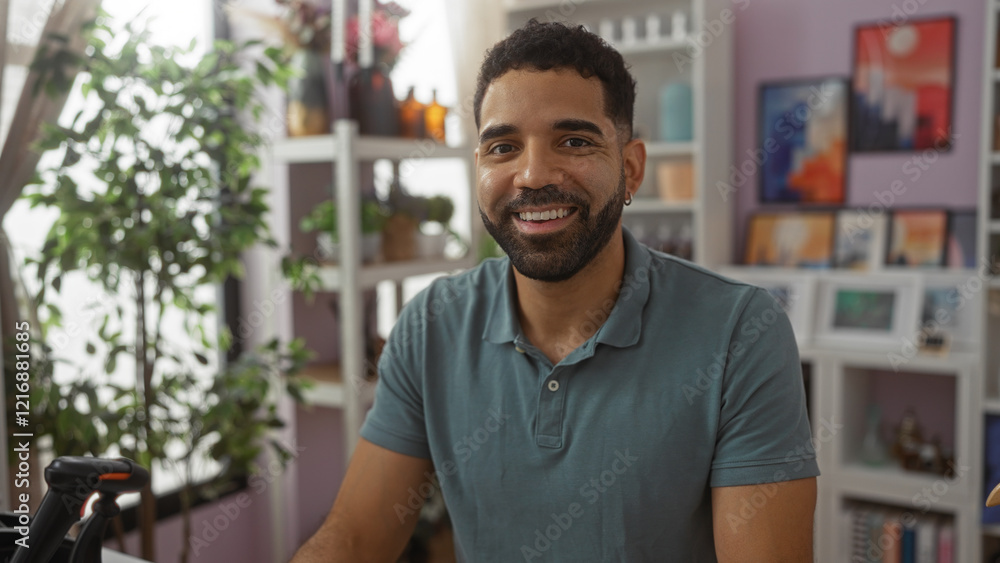 Handsome man smiling in a home decor store with indoor plants and colorful artwork in the background Handsome man smiling in a home decor store with indoor plants and colorful artwork in the background