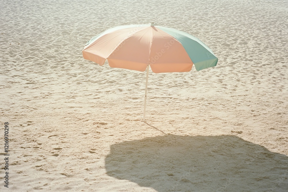 A pastel-colored beach umbrella casting a soft shadow on the sand. picture A pastel-colored beach umbrella casting a soft shadow on the sand. picture