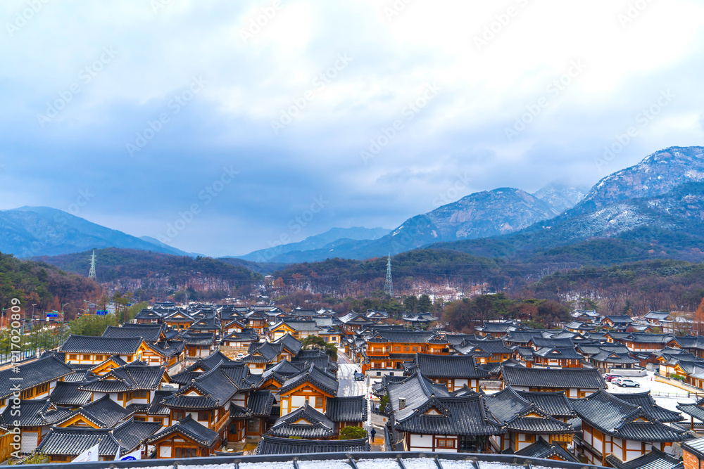 Fototapeta premium Seoul, South Korea Aerial and Winter View of Eunpyeong Hanok Village Houses. Tiled Roofs with Thin Snow Covering of Eunpyeong Hanok Village Houses in Seoul, South Korea