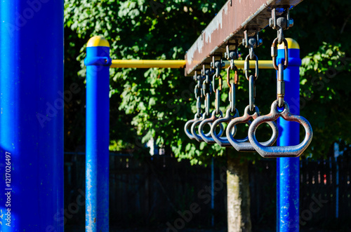 Close-up of a section of manual playground equipment to swing from.