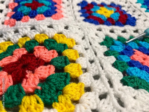 Granny square crocheted blanket with different colors motives, retro vintage craft handmade handiwork crocheting, beautiful plied photo cozy winter or autumn background wool thing yarn lovely warm photo