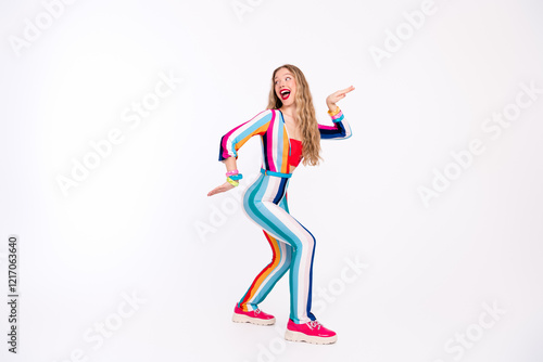 Young woman in vibrant, striped outfit dancing joyfully against a white background, capturing the essence of retro disco vibes photo