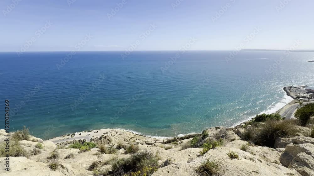 Scenic cliffside beach overlooking vast blue sea on a calm day Scenic cliffside beach overlooking vast blue sea on a calm day