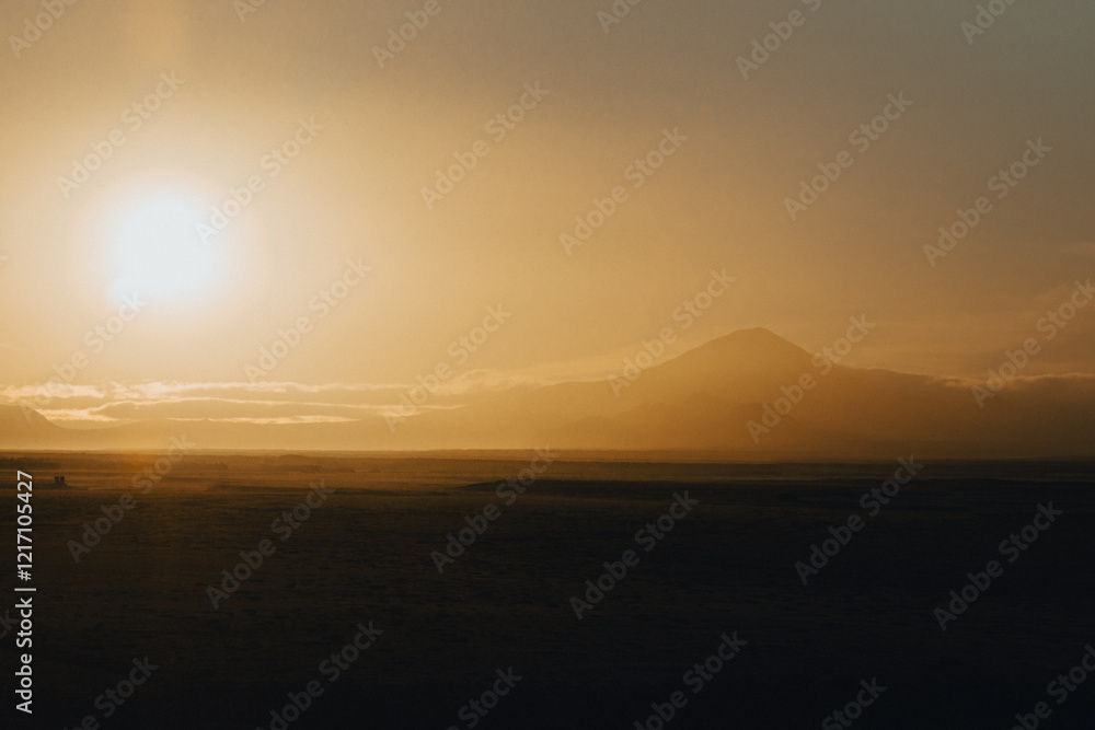 Golden sunrise over Hekla volcano in South Iceland, creating a serene landscape. Golden sunrise over Hekla volcano in South Iceland, creating a serene landscape.