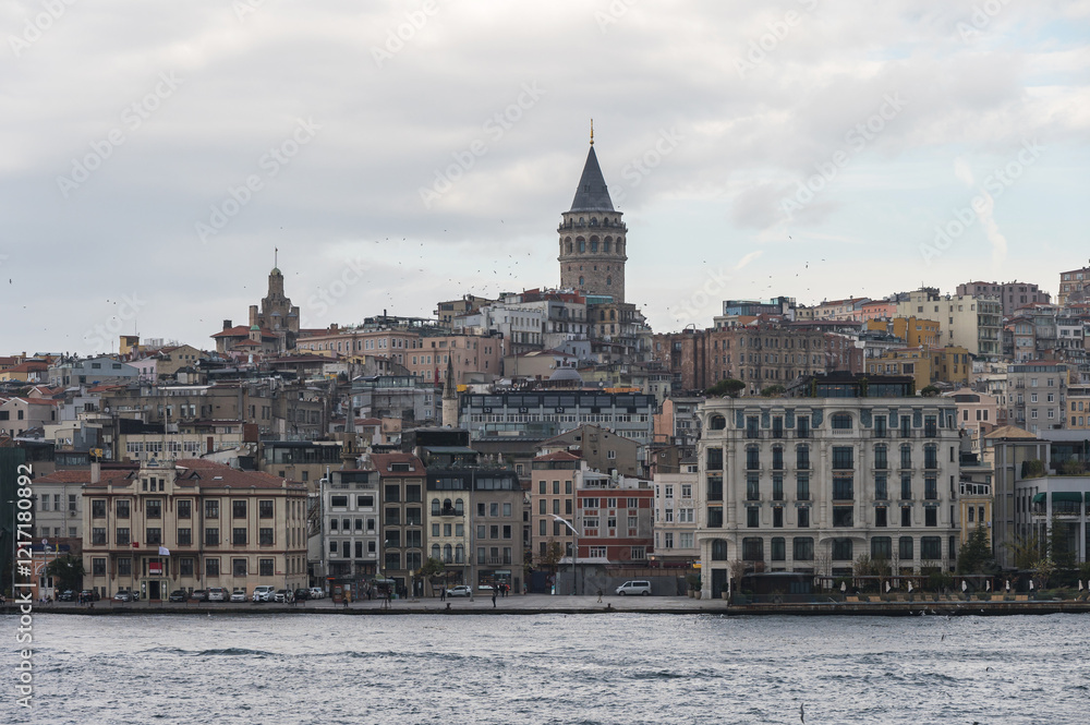 Fototapeta premium View of the Galata Tower, Beyoglu district, Istanbul, Turkey. 14th-century city landmark. Golden horn urban waterway