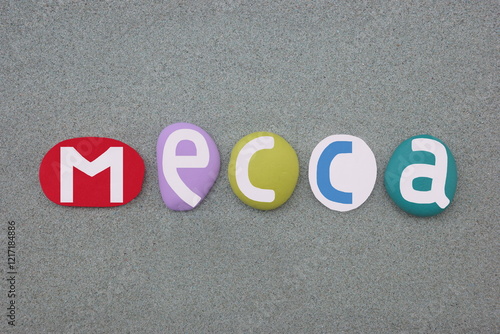 Mecca, the capital of Mecca Province in the Hejaz region of western Saudi Arabia, souvenir composed with multi colored hand painted stone letters over green sand photo