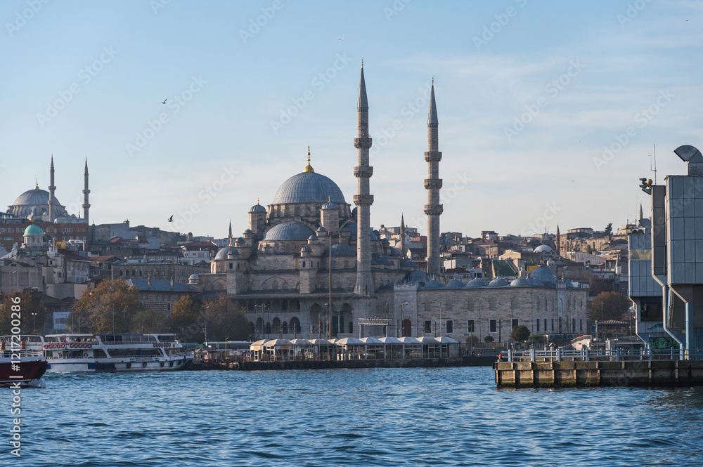 Fototapeta premium New mosque on a sunny day, Eminonyu district, Istanbul, Turkey. View from Galata Bridge