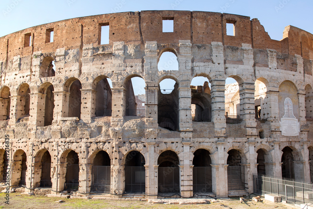Fototapeta premium Closeup of the facade of the Colosseum. It is an elliptical amphitheater in the center of the city of Rome, Italy,