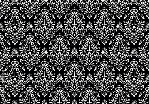 Wallpaper in the style of Baroque. Seamless vector background. White and black floral ornament. Graphic pattern for fabric, wallpaper, packaging. Ornate Damask flower ornament.