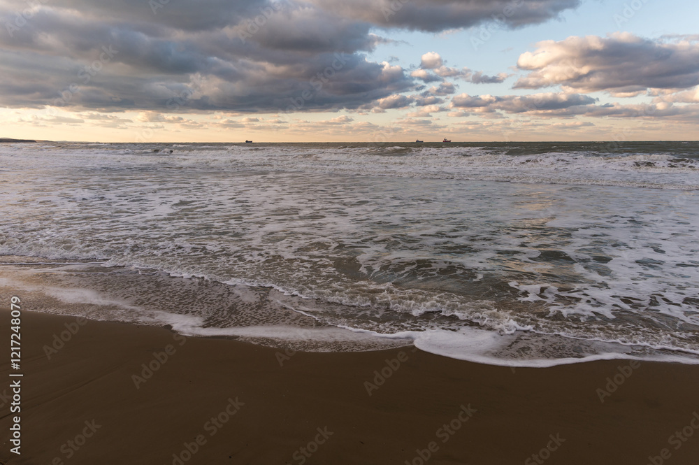 Stunning sunset view of Kumkoy beach. Black sea, amazing sky and boats in the distance. Turkey, Kumköy Stunning sunset view of Kumkoy beach. Black sea, amazing sky and boats in the distance. Turkey, Kumköy