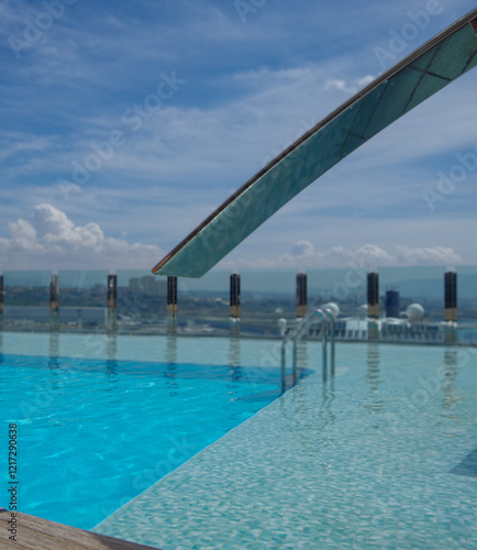 Outdoor infinity swimming pool onboard modern luxury cruiseship cruise ship liner with turquoise water under summer cloud sky photo