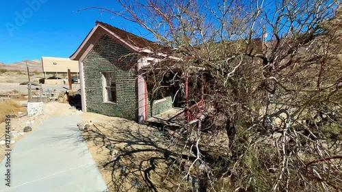 Unique architectural curiosity showcases a historic bottle house in the eerie Rhyolite ghost town near Death Valley, exemplifying innovative frontier resourcefulness and preserving a glimpse of early 