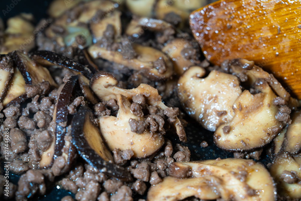 stir-frying the seasoned beef and shiitake mushroom