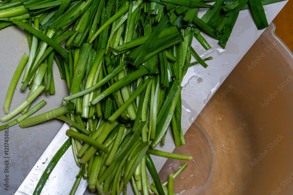 moving knife-cut chives from the cutting board to the bowl