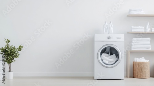 Modern and Minimalistic Laundry Room with White Washing Machine and Clean Towels on Shelves photo