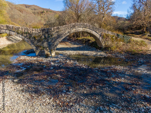 Aerial drone view of the traditional stone Mylos Bridge in Epirus, Greece in Autumn photo