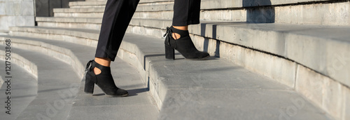 Legs of businesswoman climbing stairs, concept of development, growth in business