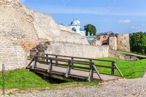 Ancient weathered rough stone walls and tower of the Izborsk fortress, Izborsk, Russia. Medieval castle of the 14th century photo