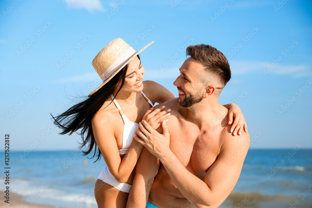 Happy young couple at beach on sunny day Happy young couple at beach on sunny day