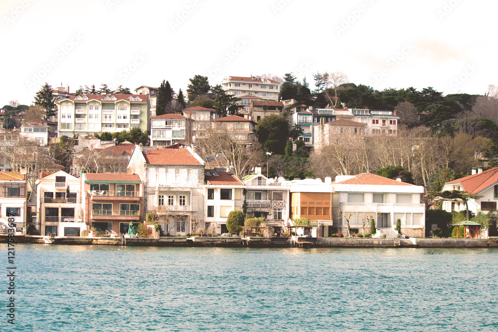 Obraz premium Waterside mansions on the Yeniköy coast. Vintage effect waterside residences. Warm tones. Touristic architectural buildings. 