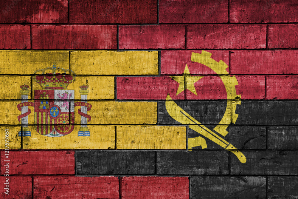 Fototapeta premium colourful painted big flag of spain and flag of angola on a massive old brick wall background. concept