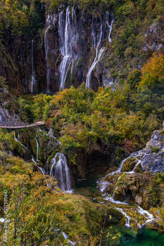 Verdant Waterfall A close-up view of waterfalls surrounded by bright green moss and foliage in Plitvice Lakes National Park