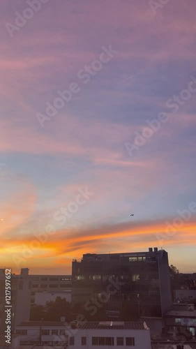 Stunning shot of a golden and pink sky with two airplanes visible in the distance