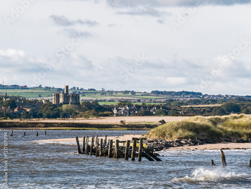 View from river Coquet to Warkworth, Northumberland, UK with medieval castle.