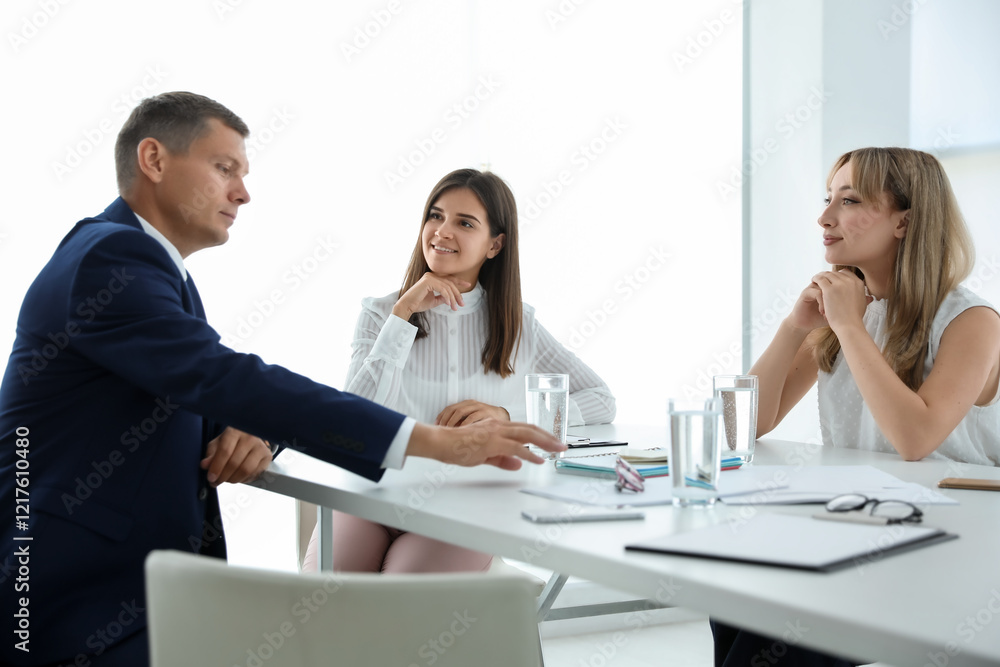 Office employees talking at table during meeting Office employees talking at table during meeting