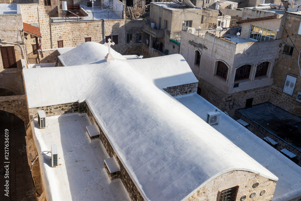 Acre, Israel, January 20, 2025. A glimpse of the ancient town and the Greek Orthodox Cathedral of St. George. The church roof is crafted as a white cross. Acre, Israel, January 20, 2025. A glimpse of the ancient town and the Greek Orthodox Cathedral of St. George. The church roof is crafted as a white cross.
