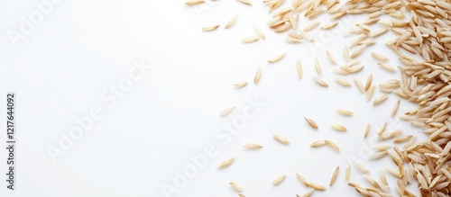 Basmati rice grains scattered on a white background with ample empty space for creative text or advertisement placement photo