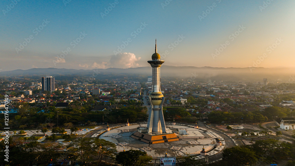 Obraz premium Aerial photo of the religious monument which is one of the icons in Kendari, Southeast Sulawesi, Indonesia at sunset. Panoramic view around the monument with residential and urban background at dusk