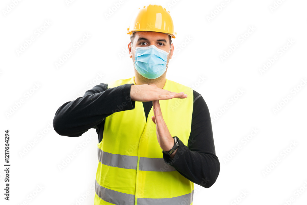 Fototapeta premium Builder wearing medical or surgical mask making timeout gesture