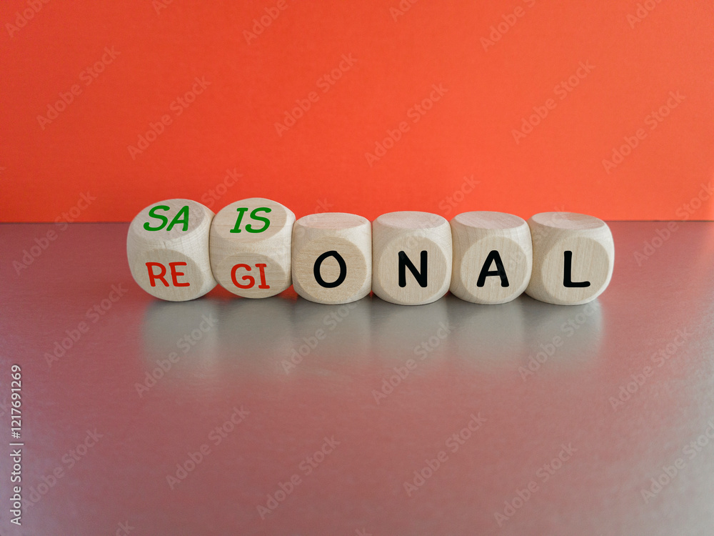 Symbol for seasonal and regional products. Cubes form the German words saisonal (seasonal) and regional. Beautiful red background, grey table.