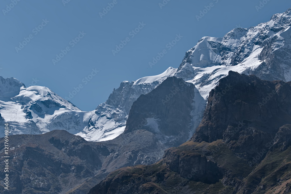 Russia. Kabardino-Balkaria. View of the snow-capped peaks of the Caucasus Mountains at sunset on an autumn day. Russia. Kabardino-Balkaria. View of the snow-capped peaks of the Caucasus Mountains at sunset on an autumn day.