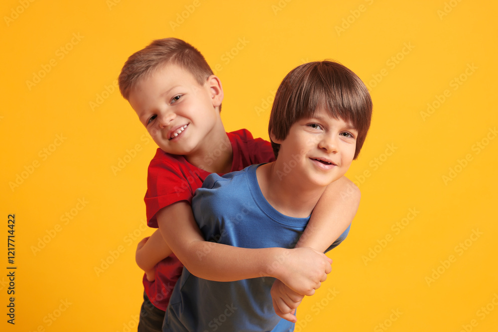 Portrait of cute brothers on orange background Portrait of cute brothers on orange background