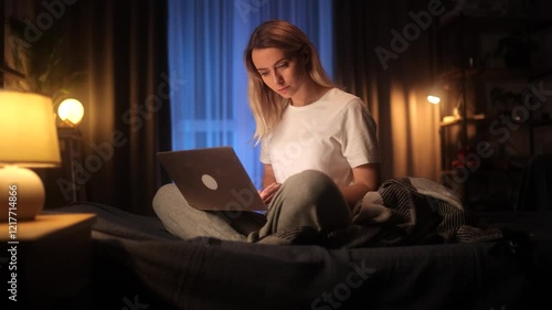 Studing at Home Online. Pretty Young Woman Using Laptop while Sitting on the Bed at Night Time. Studing at Home Online