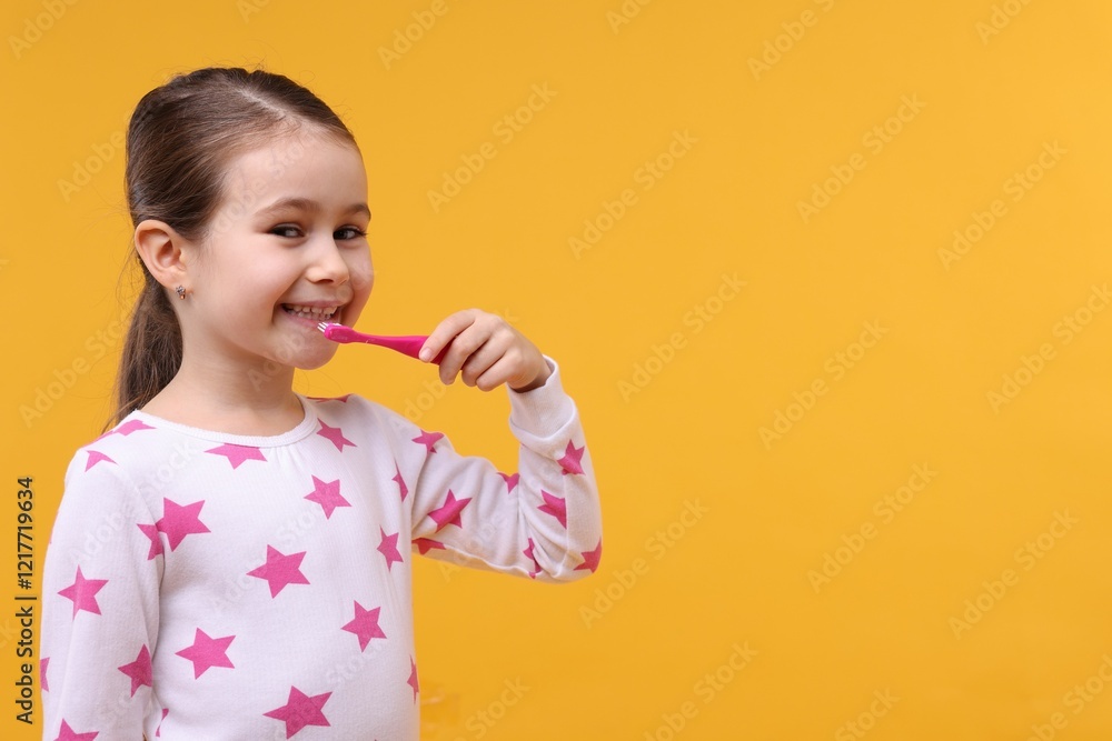 Cute girl brushing her teeth on orange background, space for text Cute girl brushing her teeth on orange background, space for text