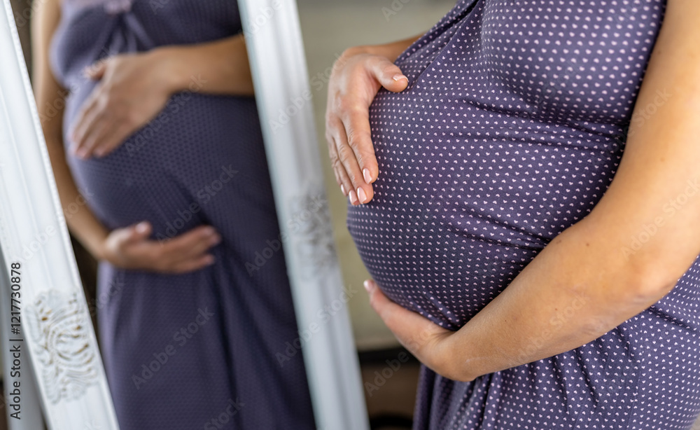 Pregnant mom admires her bump. A pregnant woman lovingly touches her baby bump while looking into a mirror, reflecting her joy and anticipation. Pregnant mom admires her bump. A pregnant woman lovingly touches her baby bump while looking into a mirror, reflecting her joy and anticipation.