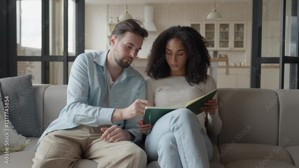 Two Cheerful Students Study in Living Room and Write Notes from Lessons Two Cheerful Students Study in Living Room and Write Notes from Lessons
