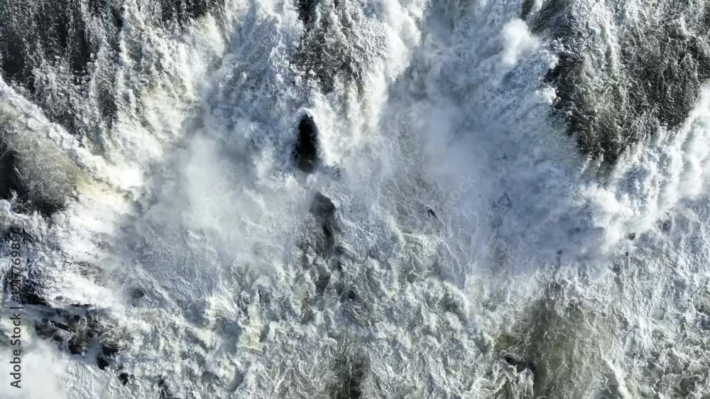 The Willamette River runs over rocks in Willamette Falls between West Linn and Oregon City, Oregon. This waterfall is the largest by volume in the Pacific Northwest.