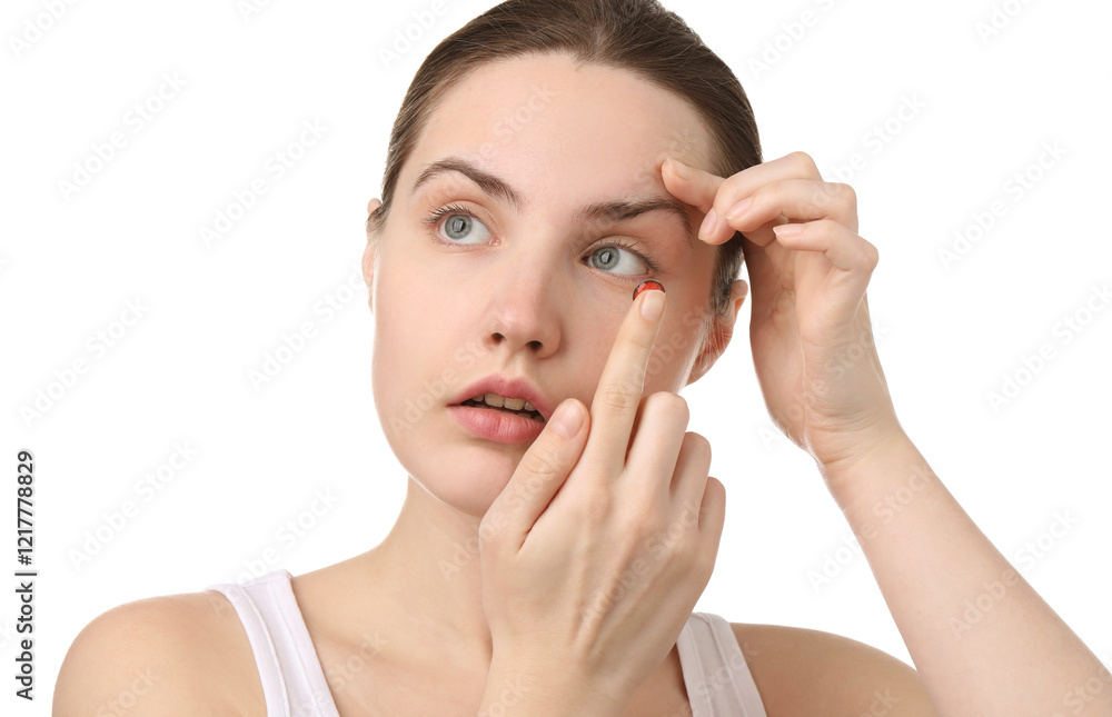 Young woman putting in red color contact lens on white background Young woman putting in red color contact lens on white background