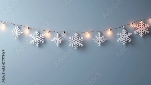 A string of lit snowflakes decorates a pale blue wall, creating a cozy winter ambiance.