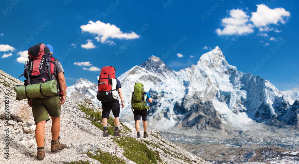 Mount Everest as seen from Kala Patthar and three hikers Mount Everest as seen from Kala Patthar and three hikers